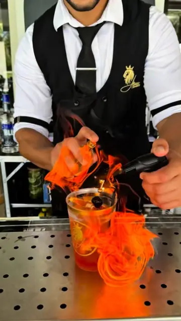 Orange peel flamed over a cocktail