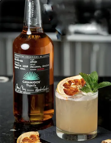 Añejo tequila cocktail with dried orange