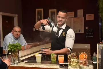 Smoking a cocktail at the bar