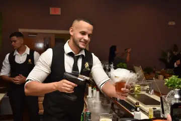 A bartender serving with a smile